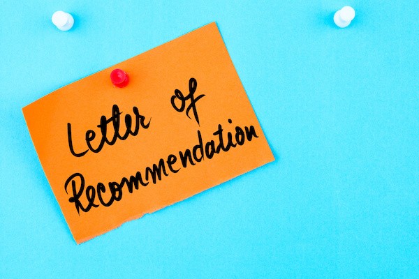 "letter of recommendation" on a sticky note stuck to the wall. 