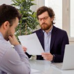 man sitting in interview wondering how important his gpa is and how to explain it
