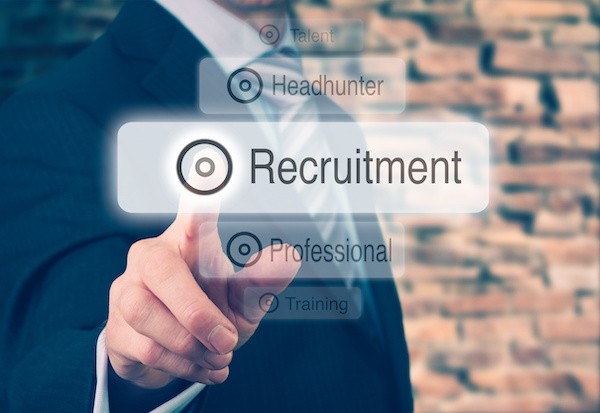 Recruitment strategies concept with businessman pressing a recruitment button.