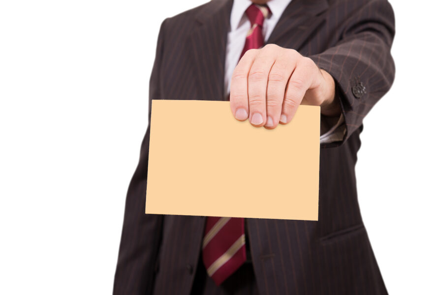 businessman or professor handing over a yellow envelop with a letter of recommendation 