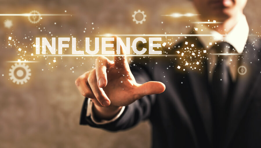 A man points to the word ‘influence’ to demonstrate choosing how to be more persuasive